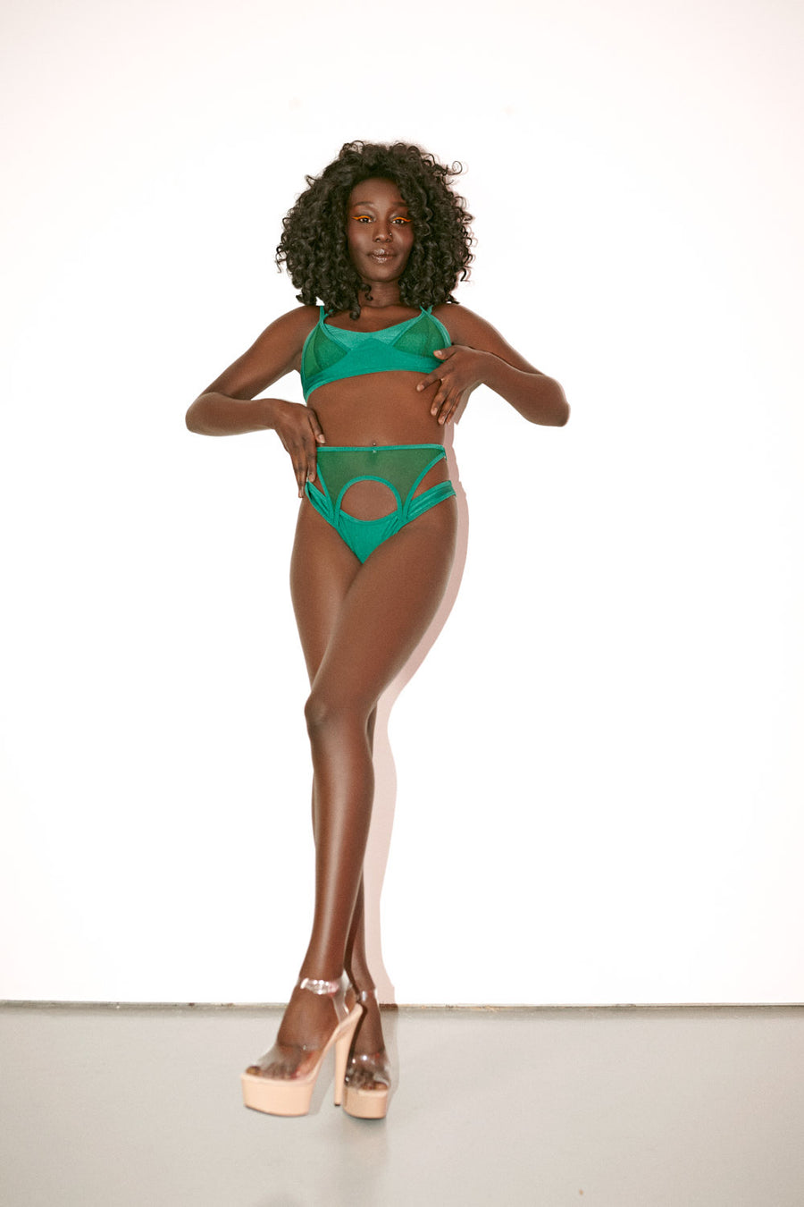 Forest green waspie bikini bottoms with mesh details model posing